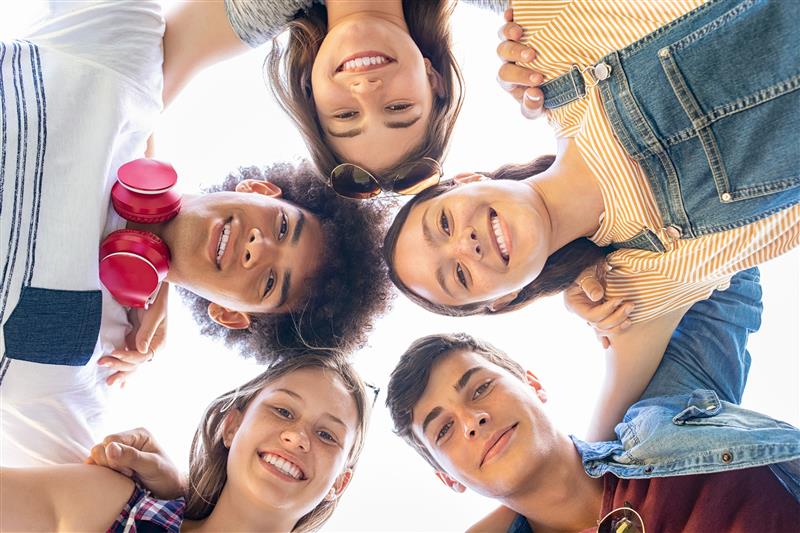 Group of diverse teens smiling outdoors